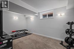 Exercise area with baseboards and carpet flooring -