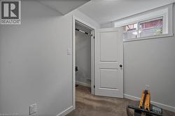 Hall featuring carpet floors and baseboards -