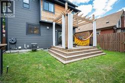 Back of property featuring a pergola -