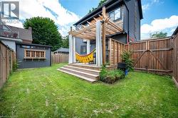 Fenced backyard with an outbuilding -