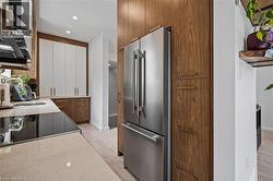Kitchen featuring high end fridge, light wood-style floors, white cabinets, electric range, and recessed lighting -