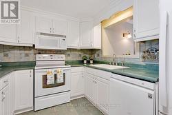 Cabinet crown molding. Ceramic backsplash & floor -