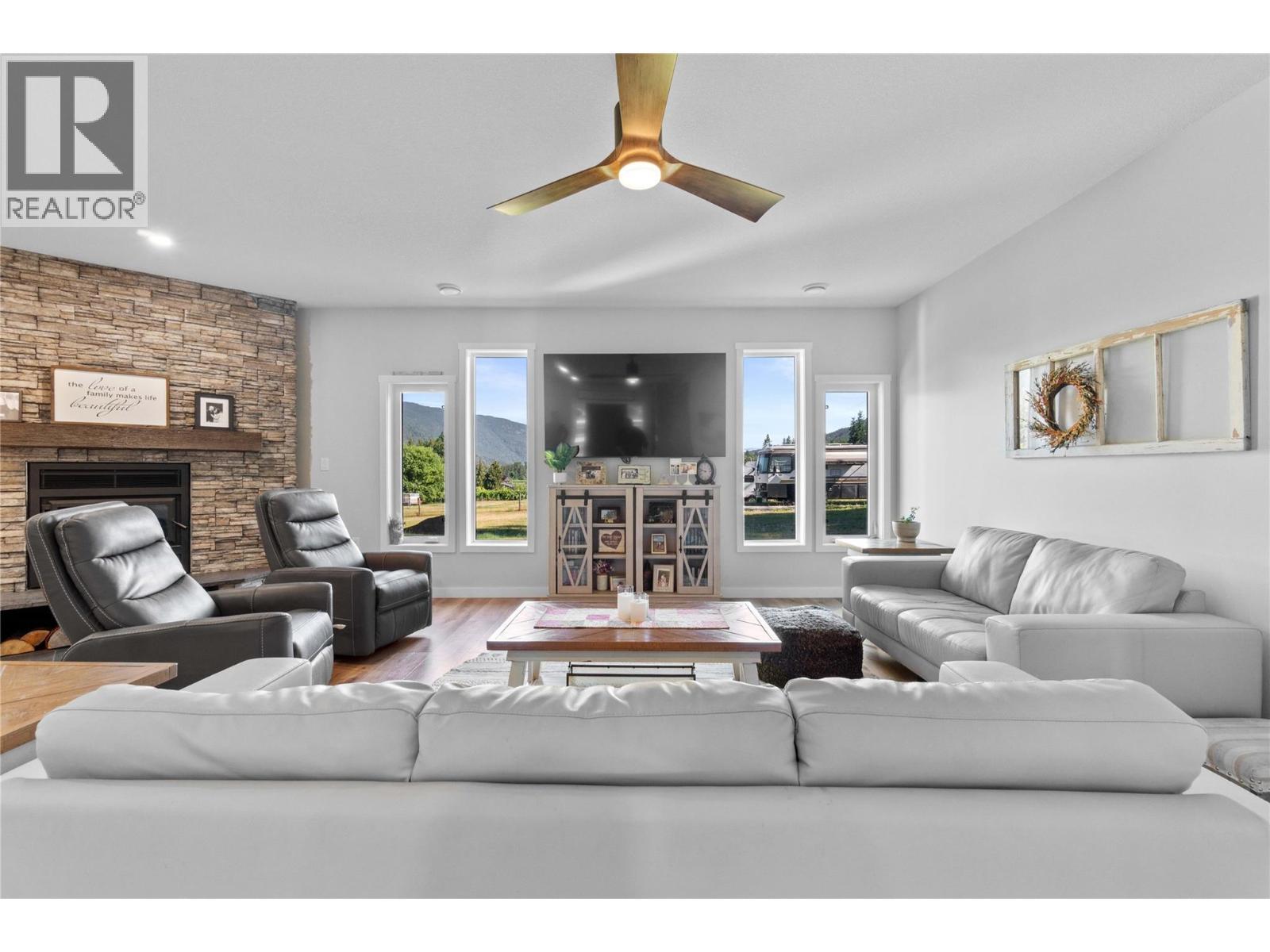 Main Living Room - 22 Parsons Road, Mara, BC - Indoor Photo Showing Living Room With Fireplace