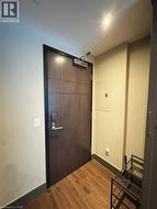 Foyer entrance with electric panel, dark wood-type flooring, baseboards, and recessed lighting -
