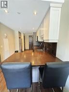 Kitchen featuring appliances with stainless steel finishes, a peninsula, a sink, white cabinetry, and recessed lighting -