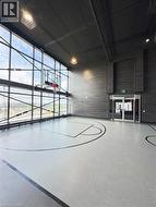 View of sport court featuring community basketball court and fence -