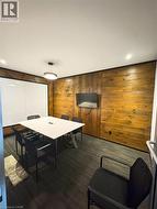 Playroom featuring dark wood-type flooring and wood walls -