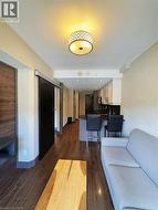 Living room featuring dark wood-type flooring, baseboards, and a textured ceiling -