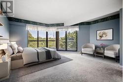 Primary bedroom w/ private balcony. Virtual stage -