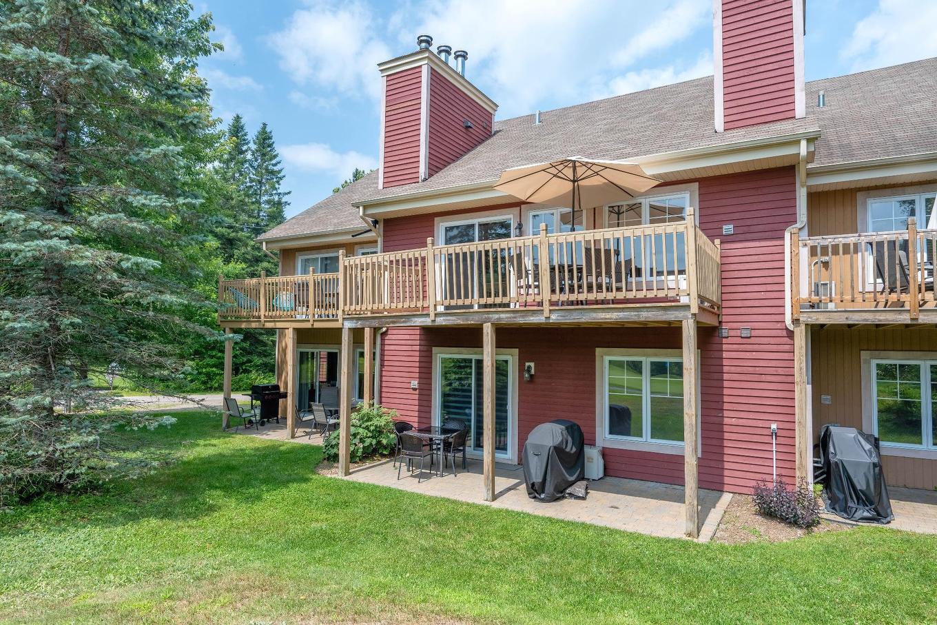 Back facade - 1808 Ch. Du Golf, Mont-Tremblant, QC - Outdoor With Balcony With Deck Patio Veranda With Exterior