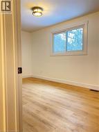 Empty room featuring light wood-type flooring and baseboards -