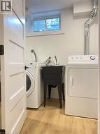 Washroom featuring light wood finished floors and washer and dryer -