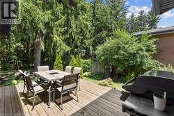 Deck with a grill and outdoor dining space -