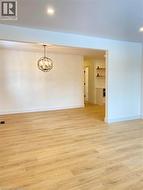 Spare room with light wood-style flooring, recessed lighting, and a chandelier -