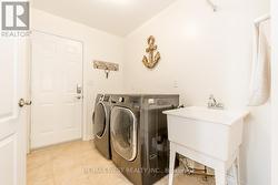 MAIN FLOOR LAUNDRY ROOM WITH GARAGE ACCESS. -