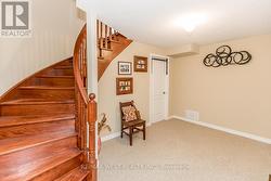 CUSTOM OAK STAIRS OPEN TO BASEMENT LANDING. -