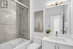 Upstairs bathroom with quartz countertops, tile flooring and tub/shower combo with tile surround -