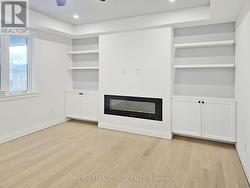 Living Room w/FP & Custom Cabinets. -
