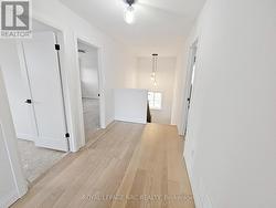 2nd floor landing. Oak stairs to upper and lower. -