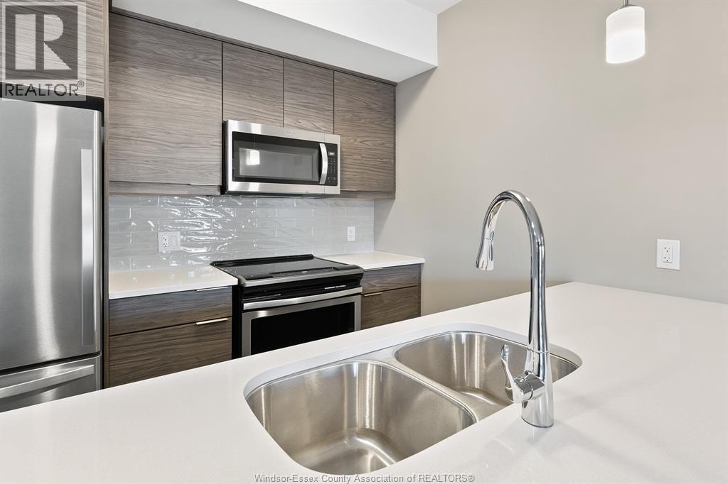 716 Brownstone Unit# 405, Tecumseh, ON - Indoor Photo Showing Kitchen With Stainless Steel Kitchen With Double Sink With Upgraded Kitchen