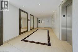 Corridor featuring inlaid floor details, elevator, recessed lighting, and tile patterned flooring -