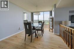 Dining area with light wood finished floors, a textured ceiling, and a chandelier -