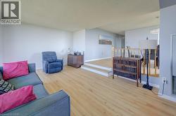 Living room with wood finished floors and a textured ceiling -