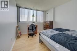 Bedroom featuring a textured ceiling and wood finished floors -