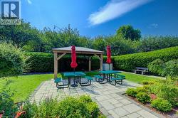 View of property's community featuring a gazebo, a yard, and a patio -