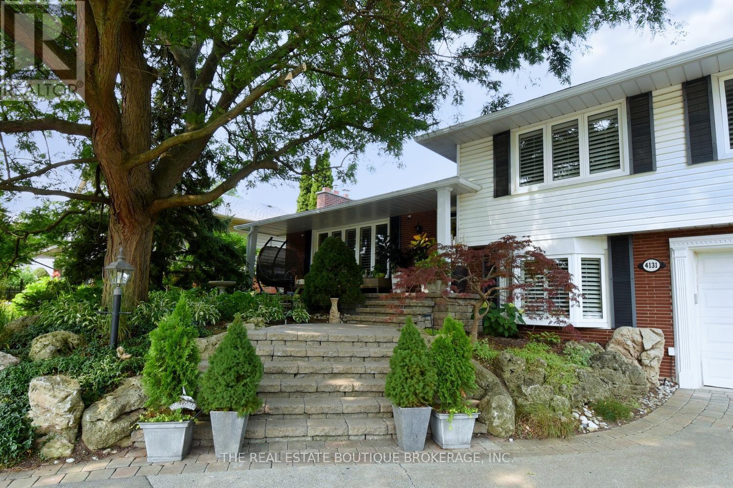 Home featuring beautifully landscaped front garden - 4131 Lorraine Crescent, Burlington, ON - Outdoor With Deck Patio Veranda