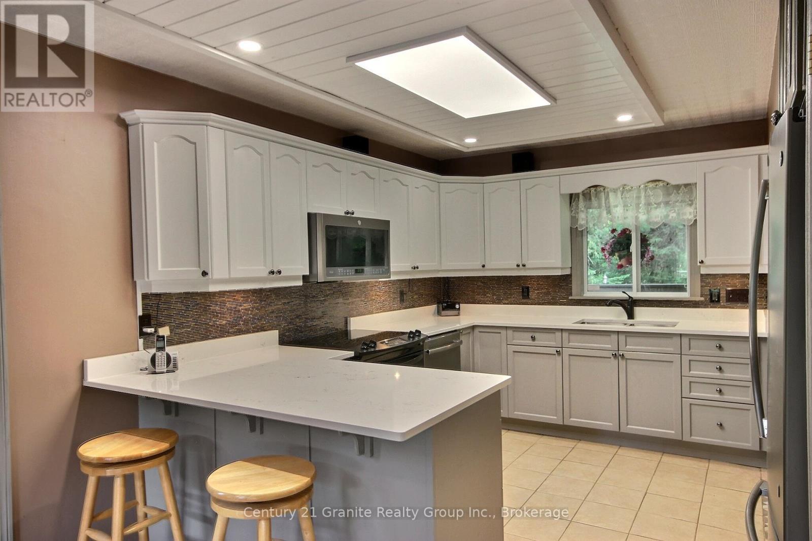 1082 Green Lake Road, Algonquin Highlands (Stanhope), ON - Indoor Photo Showing Kitchen With Double Sink