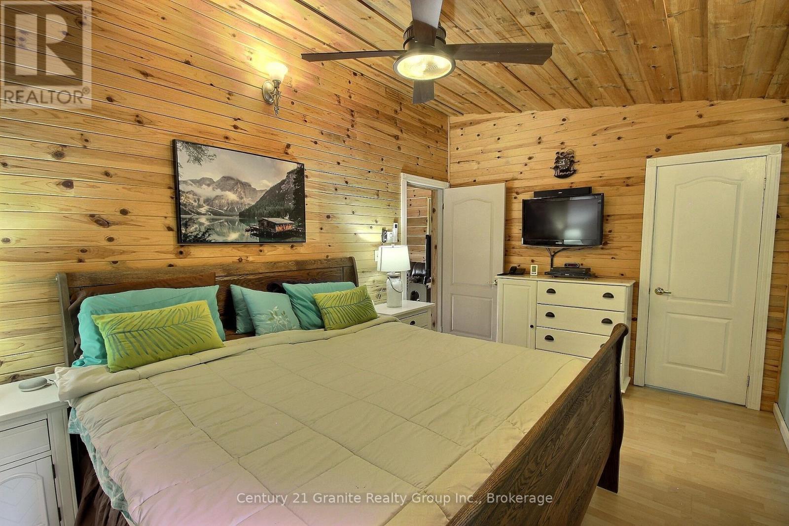 His and hers TV's - 1082 Green Lake Road, Algonquin Highlands (Stanhope), ON - Indoor Photo Showing Bedroom