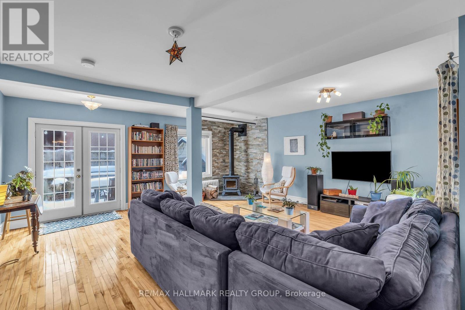 Family room with double doors to back deck - 396 Daly Avenue, Ottawa, ON - Indoor Photo Showing Living Room With Fireplace