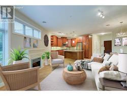 Living room with electric fireplace to kitchen and dining (photo has been virtually staged) -