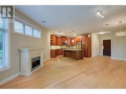 Living room with electric fireplace to kitchen and dining -