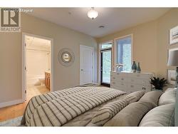 Primary bedroom with ensuite, walk-in closet and access to covered patio (photo has been virtually staged) -
