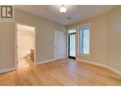 Primary bedroom with ensuite, walk-in closet and access to covered patio -