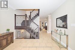 Foyer with wood staircase and ironrod spindles -