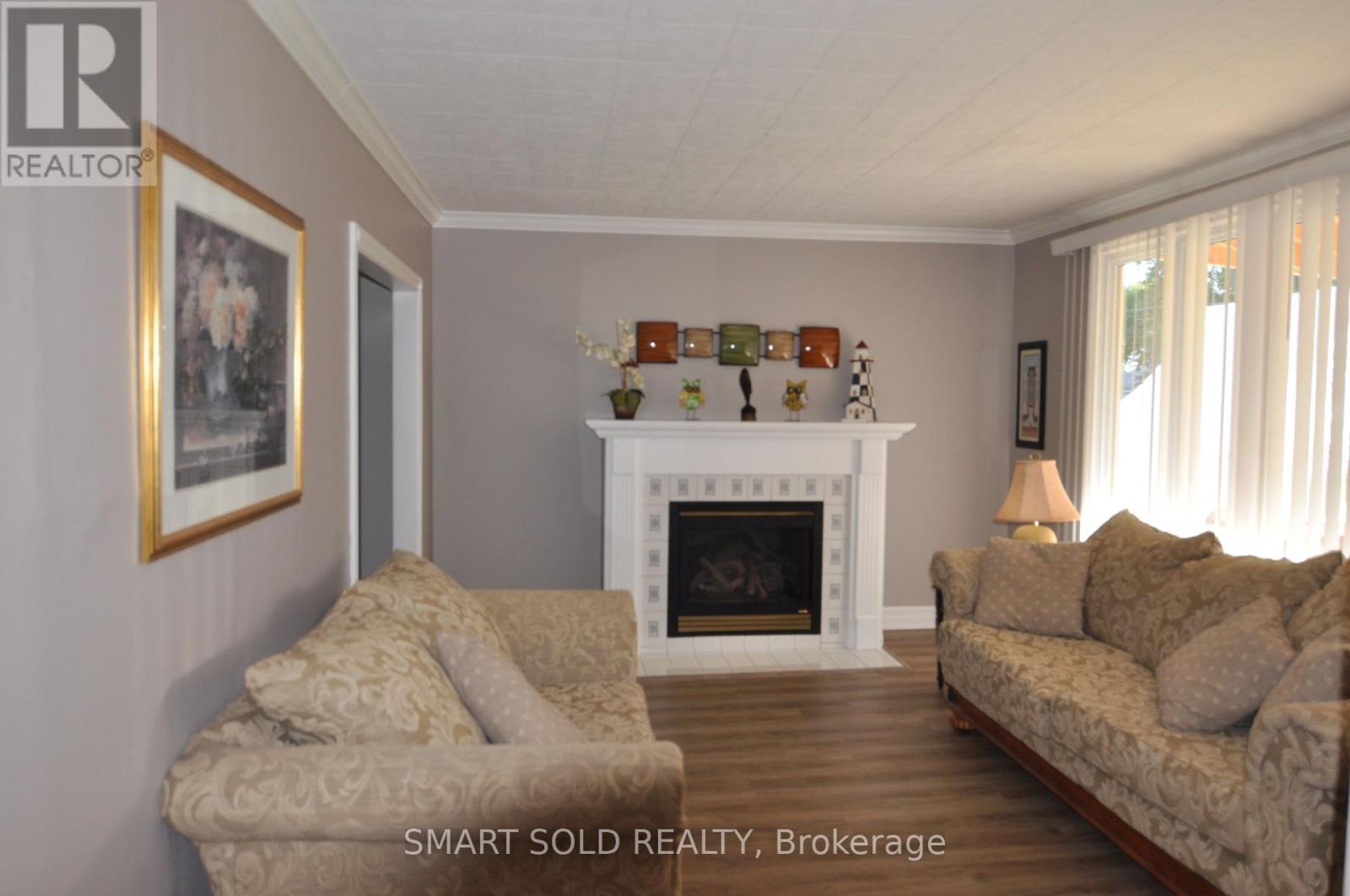 75 Lake Avenue, Ramara, ON - Indoor Photo Showing Living Room With Fireplace