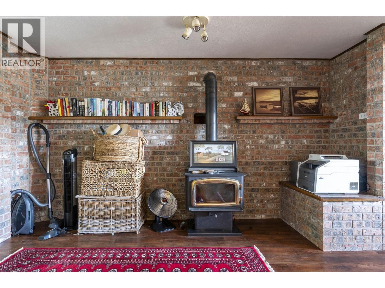 4243 Saratoga Road, Scotch Creek, BC - Indoor Photo Showing Other Room With Fireplace