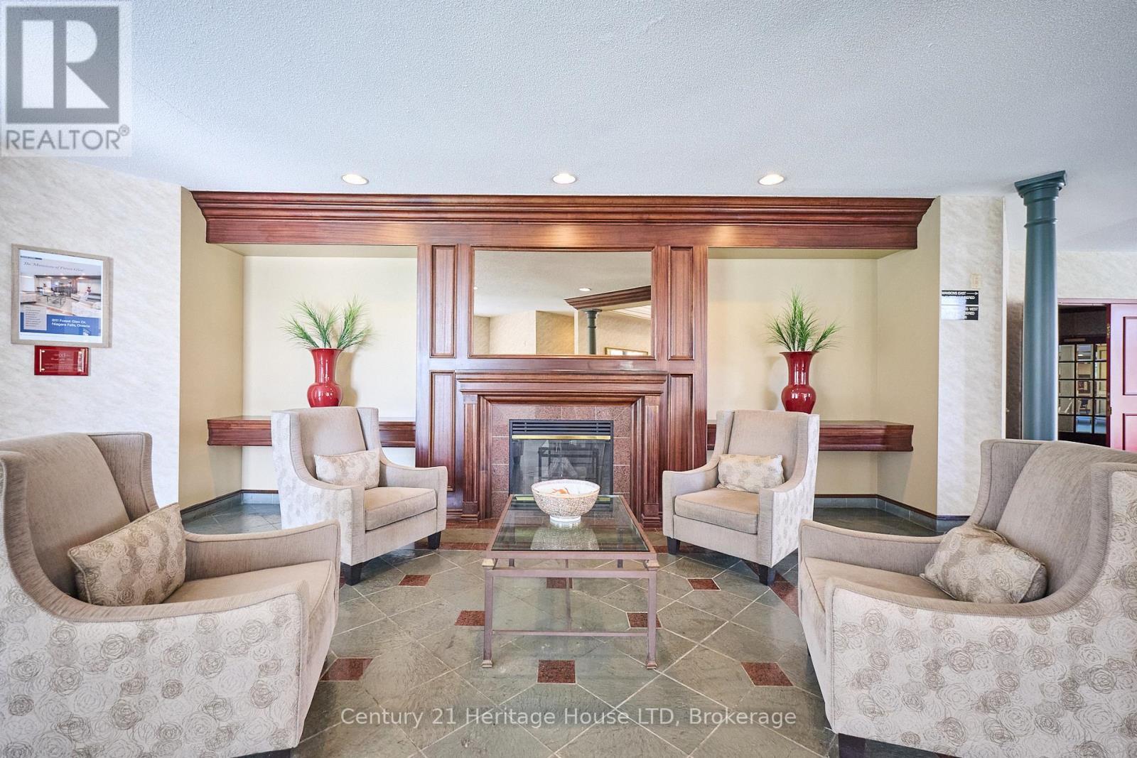317 - 8111 Forest Glen Drive, Niagara Falls (Mt. Carmel), ON - Indoor Photo Showing Living Room With Fireplace
