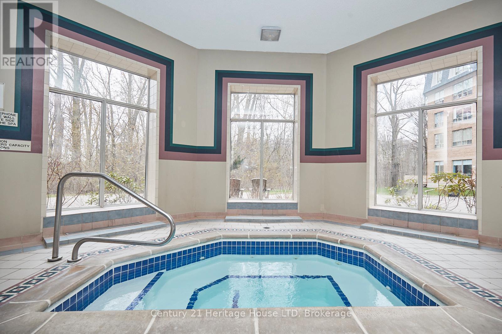 317 - 8111 Forest Glen Drive, Niagara Falls (Mt. Carmel), ON - Indoor Photo Showing Other Room With In Ground Pool