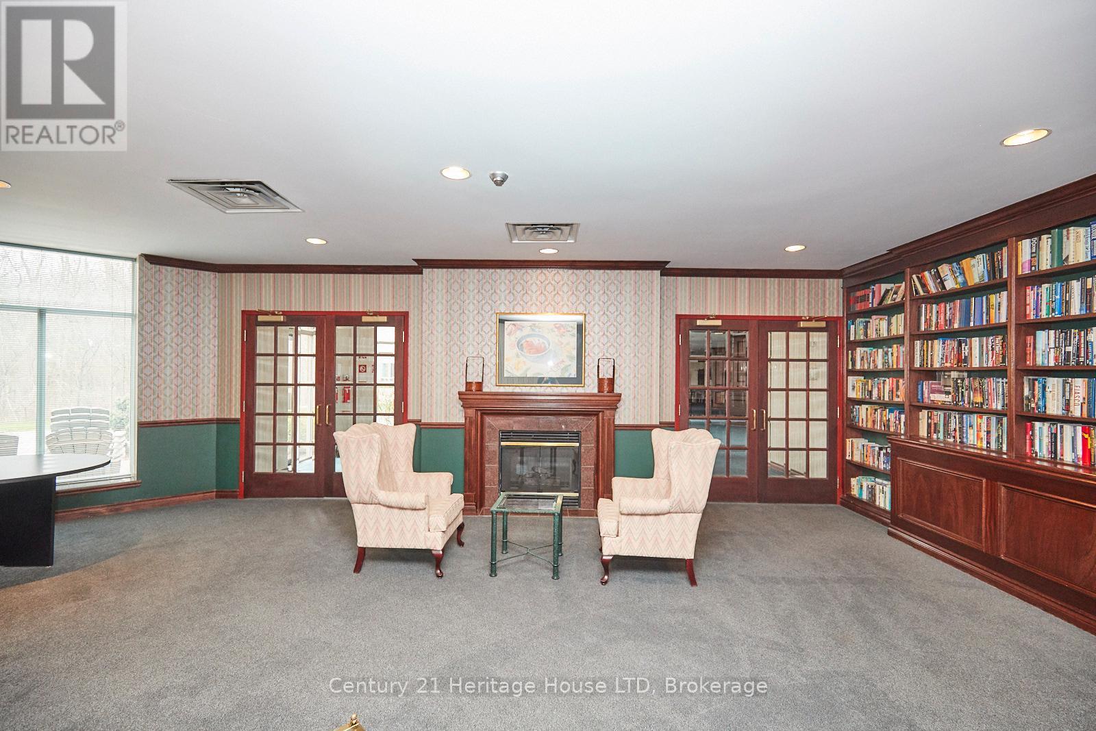 317 - 8111 Forest Glen Drive, Niagara Falls (Mt. Carmel), ON - Indoor Photo Showing Other Room With Fireplace