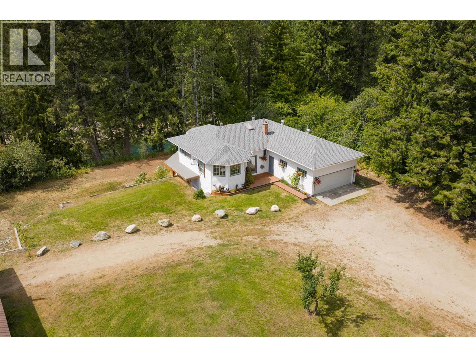 Main house that overlooks the river. - 2697 Osachoff Road, South Slocan, BC - Outdoor With Deck Patio Veranda