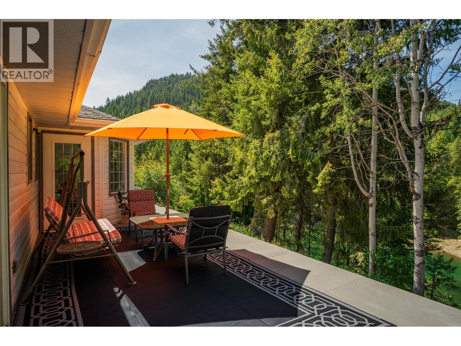 Patio in the main house that overlooks the river. - 2697 Osachoff Road, South Slocan, BC - Outdoor With Deck Patio Veranda