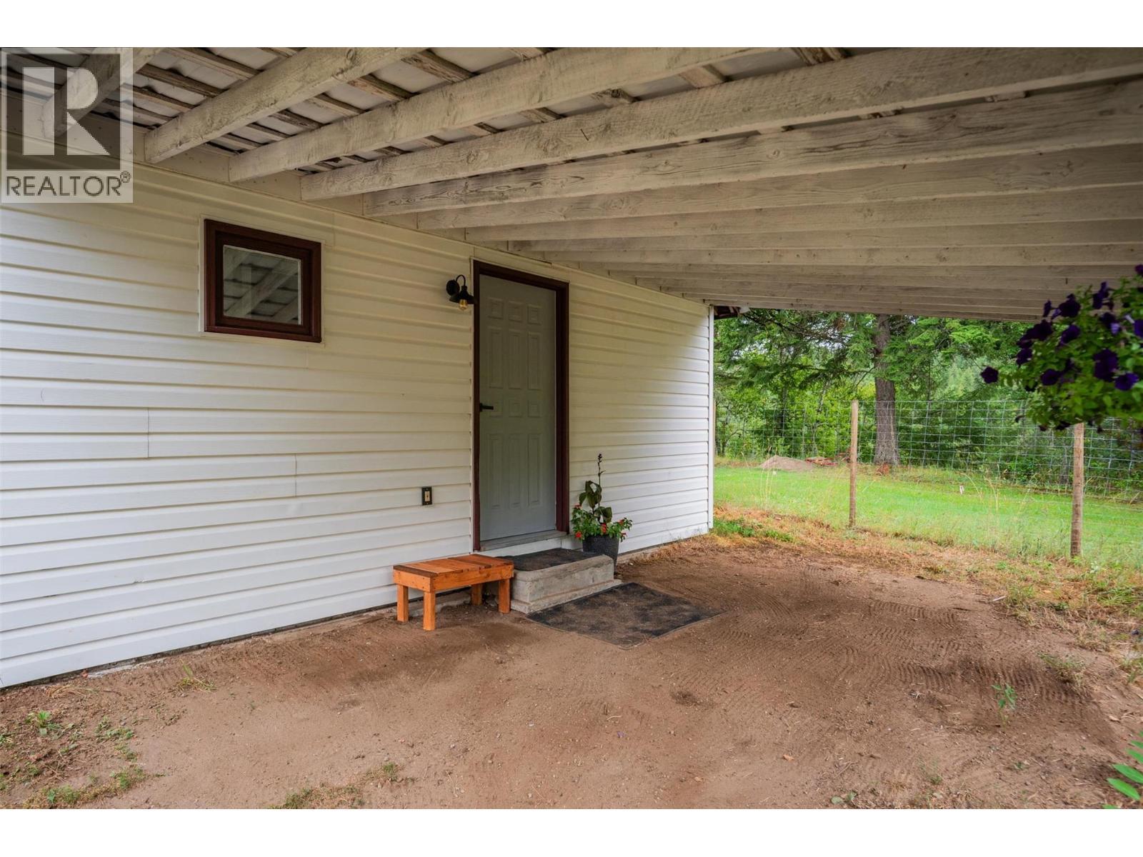 Entrance under the carport into the small house. - 2697 Osachoff Road, South Slocan, BC - Outdoor With Deck Patio Veranda With Exterior