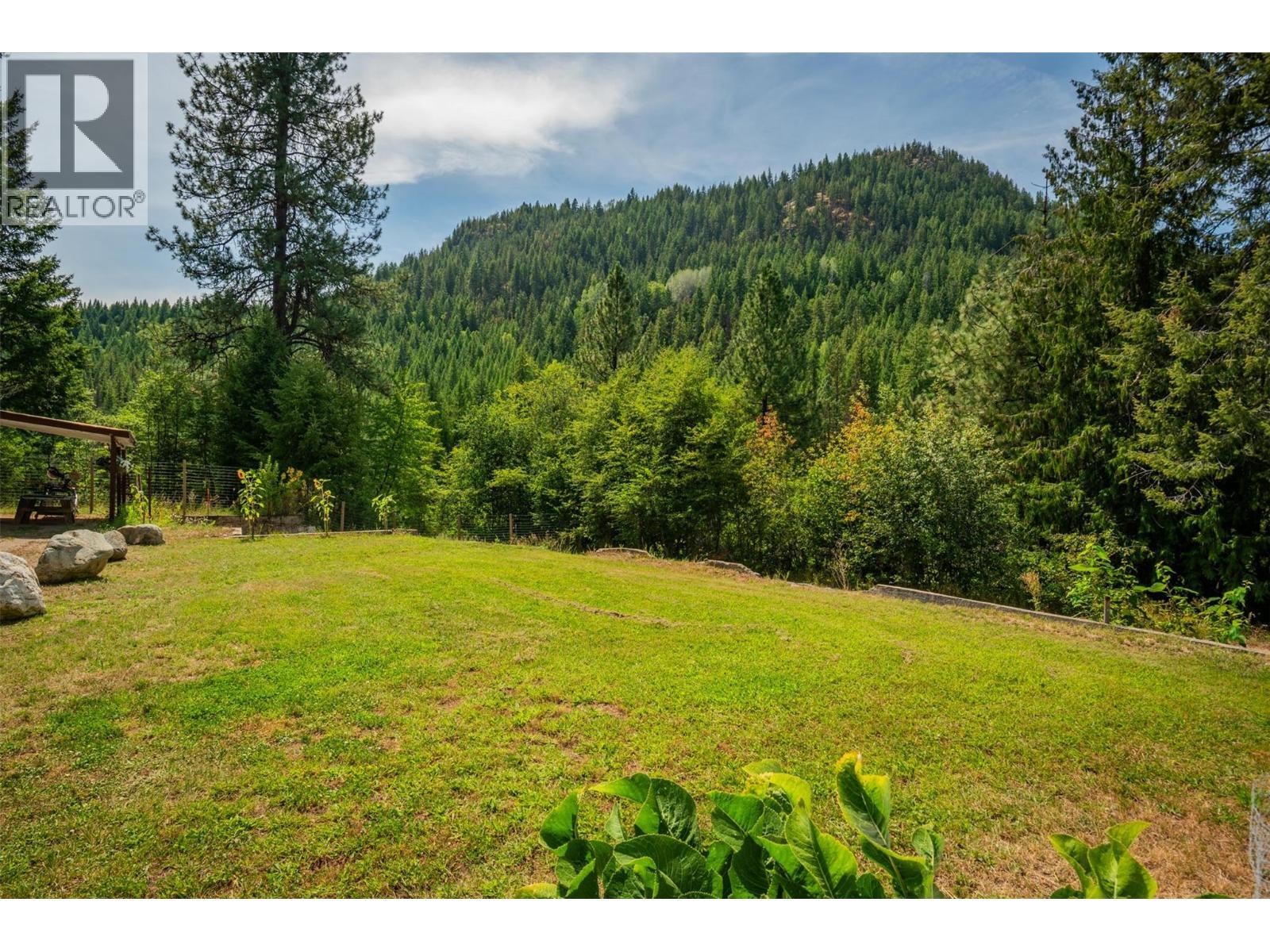 Back yard of the main house. - 2697 Osachoff Road, South Slocan, BC - Outdoor With View