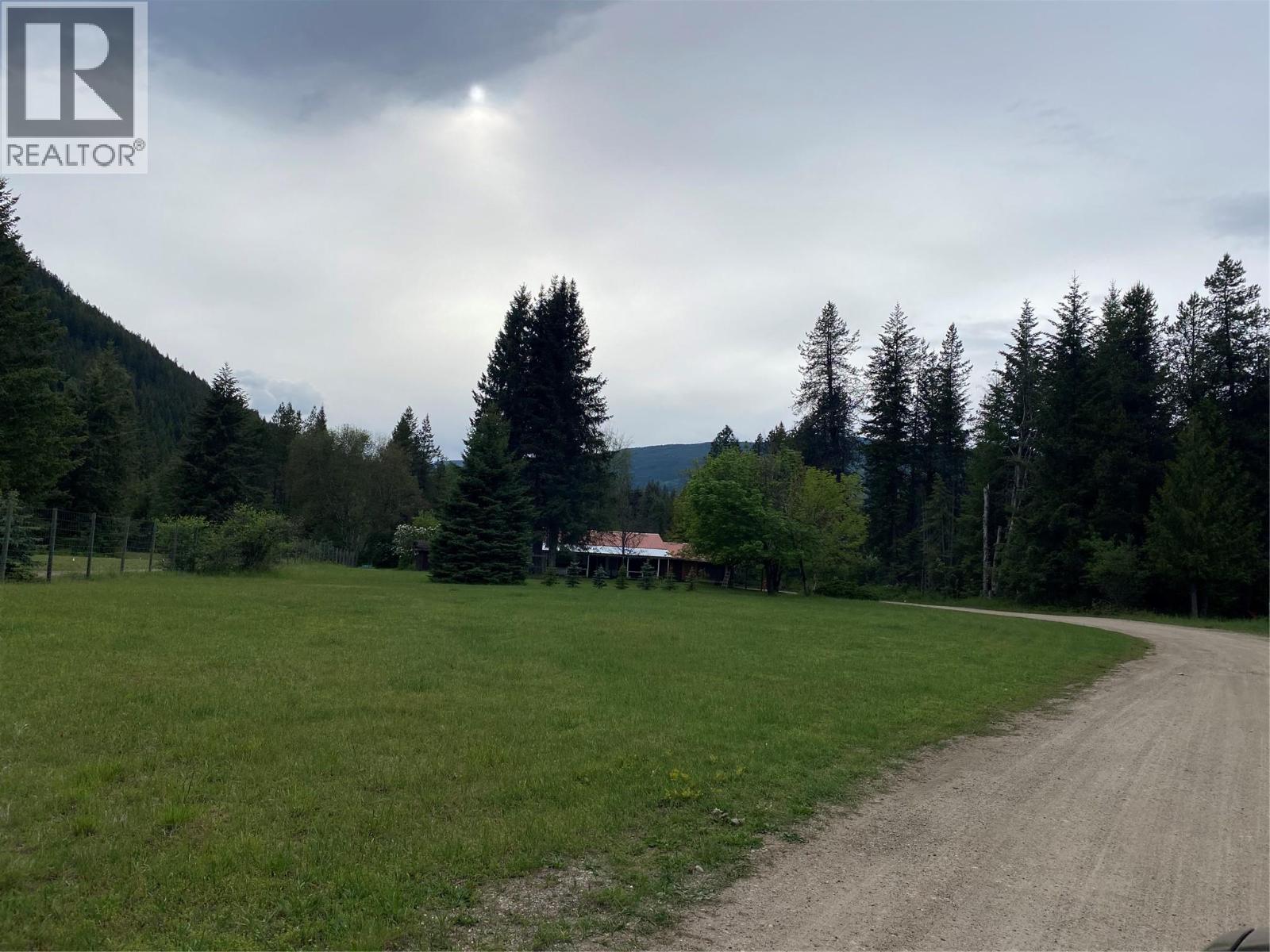 Front yard of the brown house. - 2697 Osachoff Road, South Slocan, BC - Outdoor With View