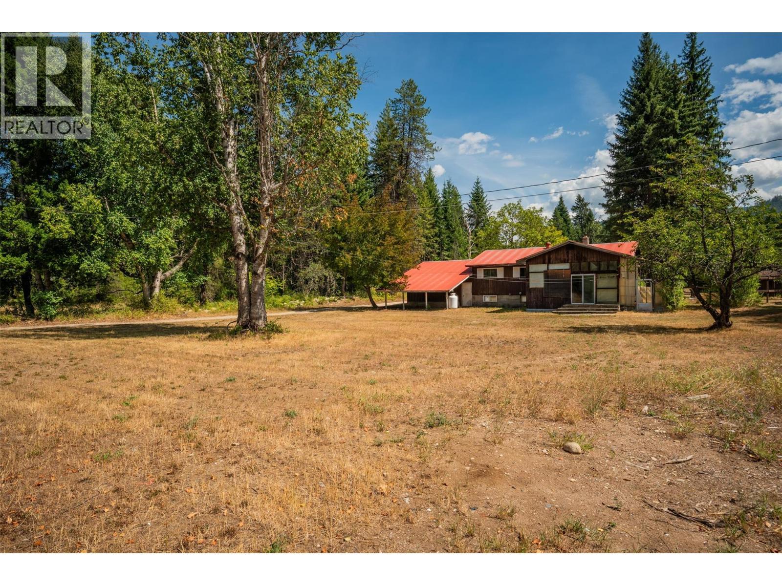 Backyard of the brown house. - 2697 Osachoff Road, South Slocan, BC - Outdoor