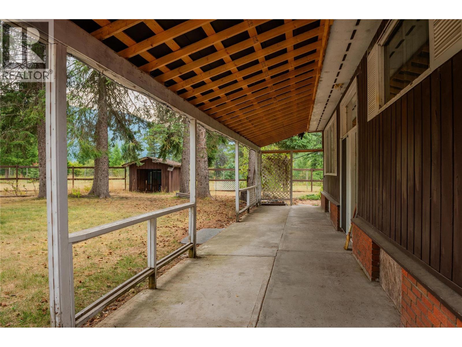 Front entrance walkway to the brown house main door. - 2697 Osachoff Road, South Slocan, BC - Outdoor With Deck Patio Veranda With Exterior